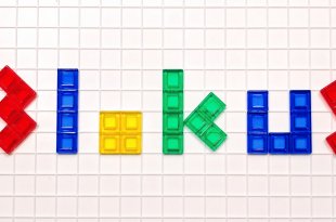 The word blokus spelled out in colored letters using Blokus game pieces on the Blokus game board