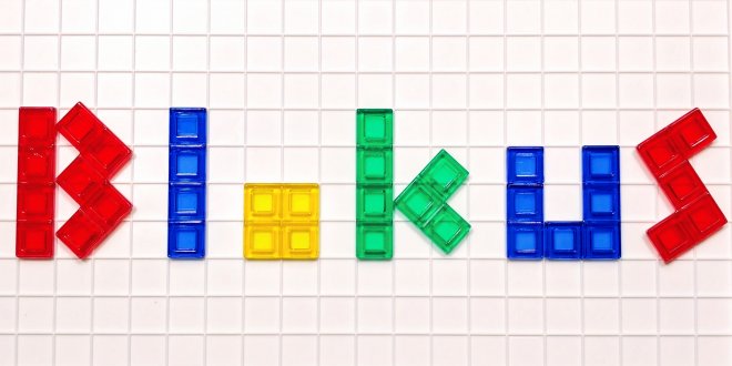 The word blokus spelled out in colored letters using Blokus game pieces on the Blokus game board