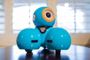 Dash Robot on a table with his eye looking up and to the right